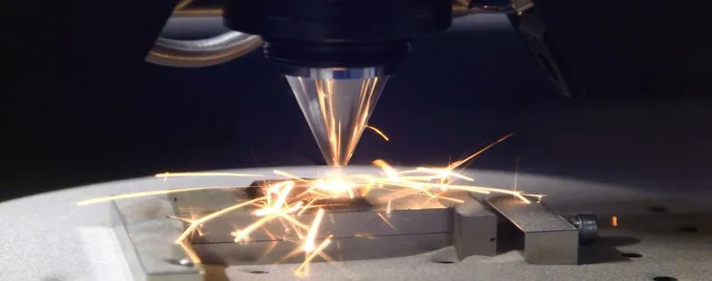 Close-up of a metal 3D printer nozzle emitting sparks while printing
