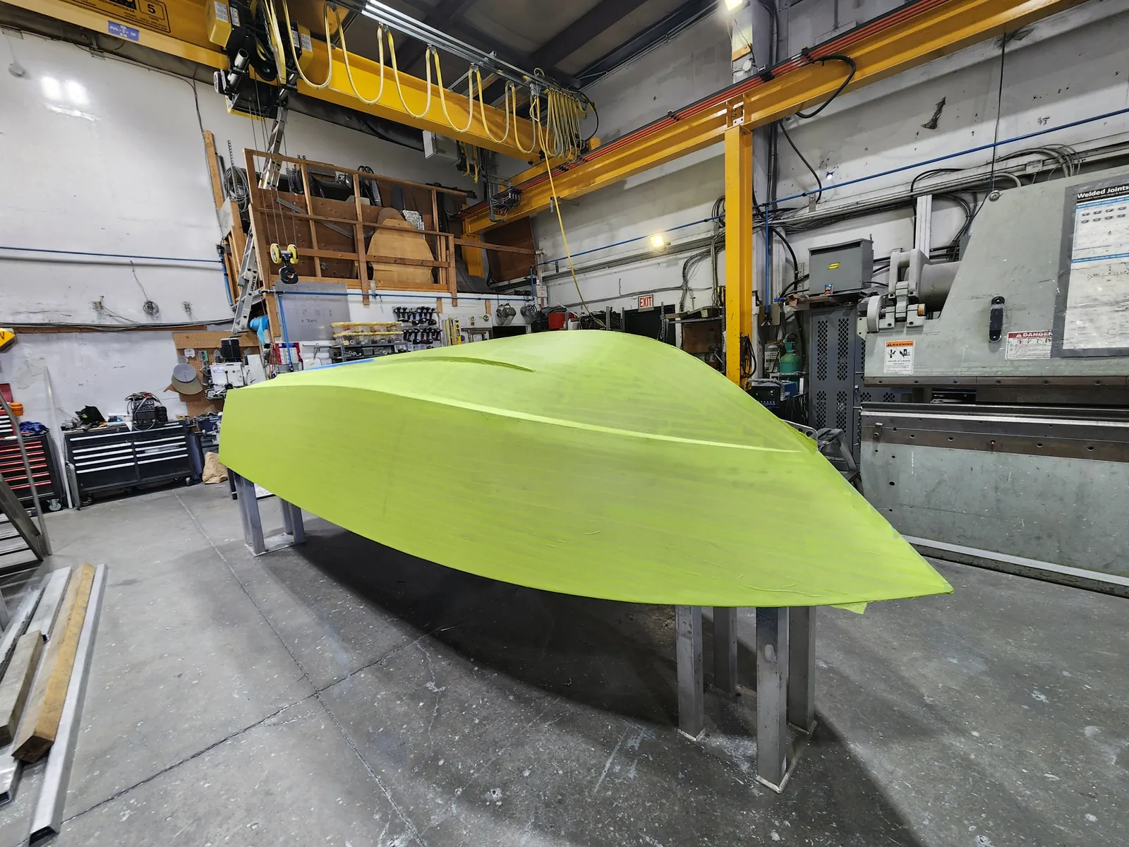 Boat hull upside down on stands, covered in scan targets