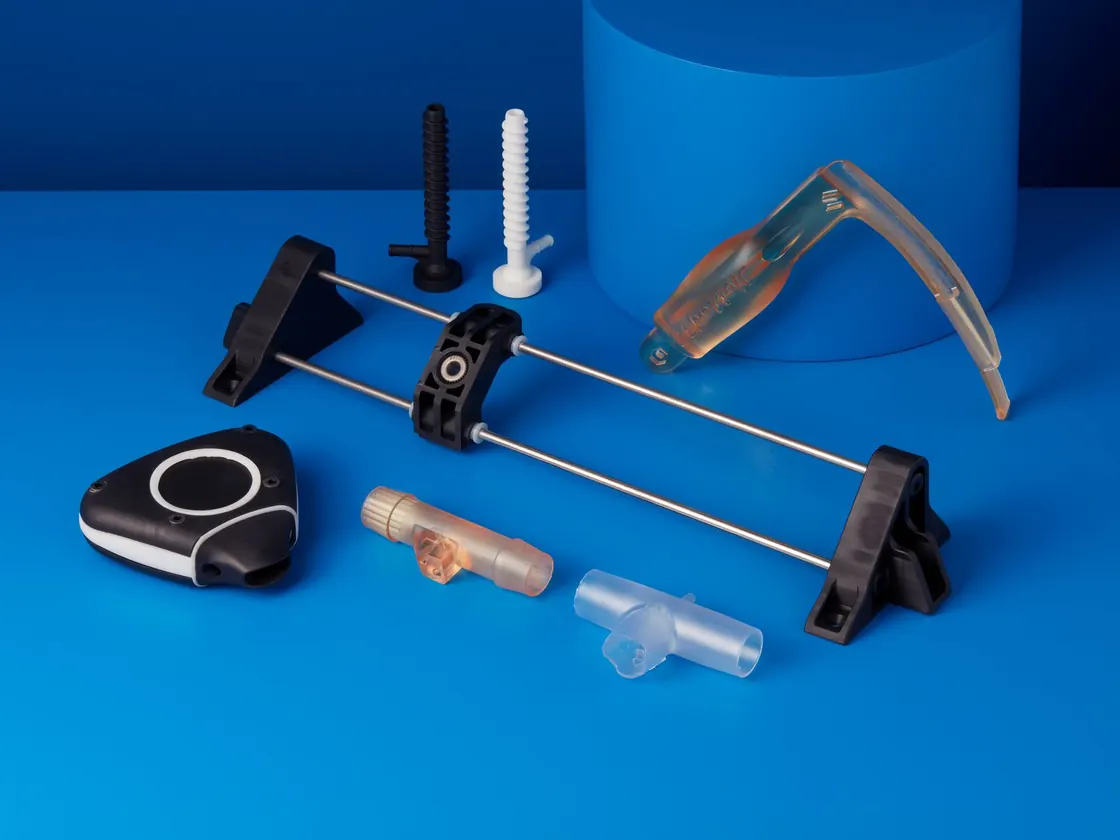 3D printed medical device prototypes on a blue background